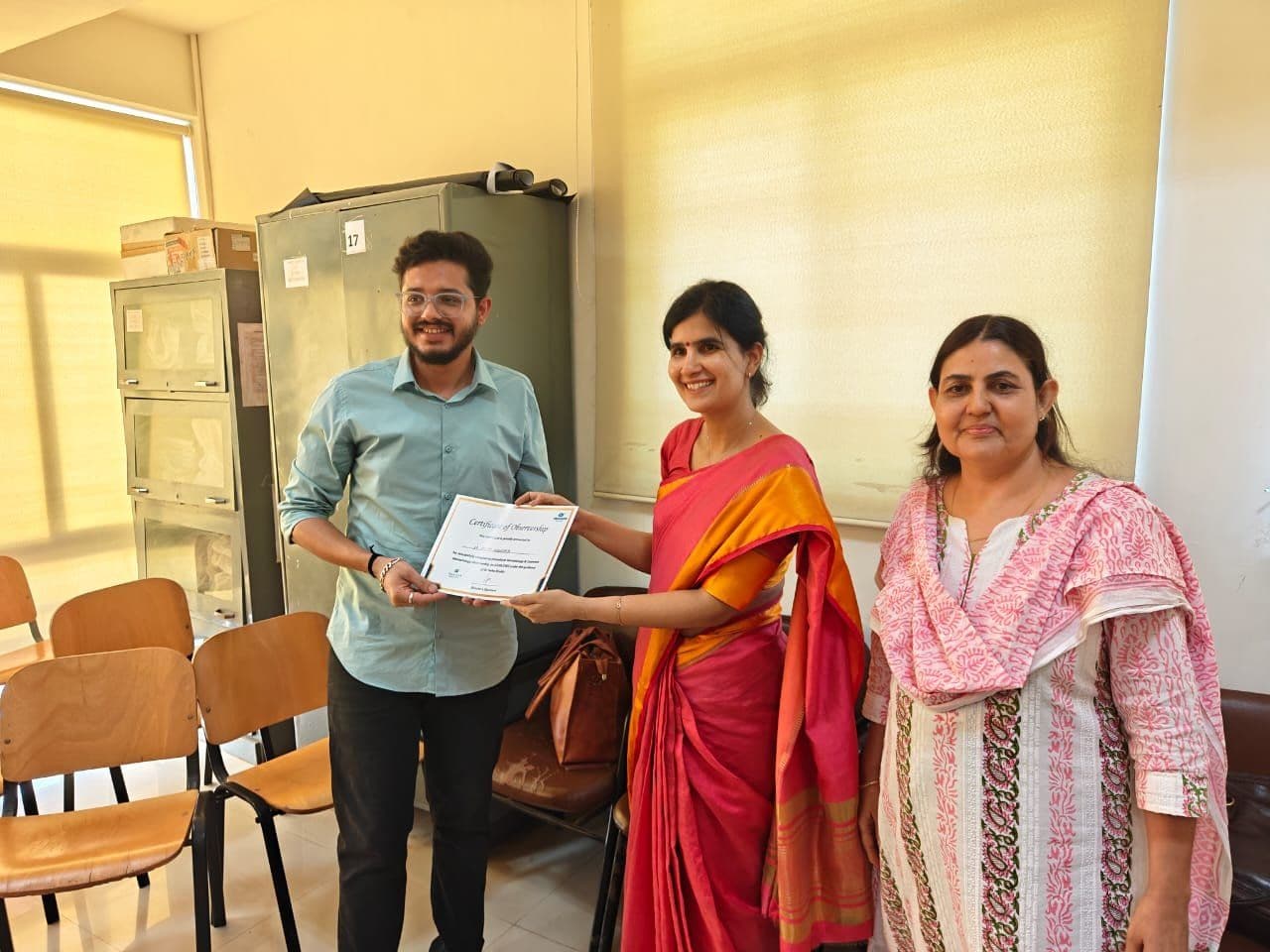 Dr. Neha Shukla presenting certificate — graduate 25