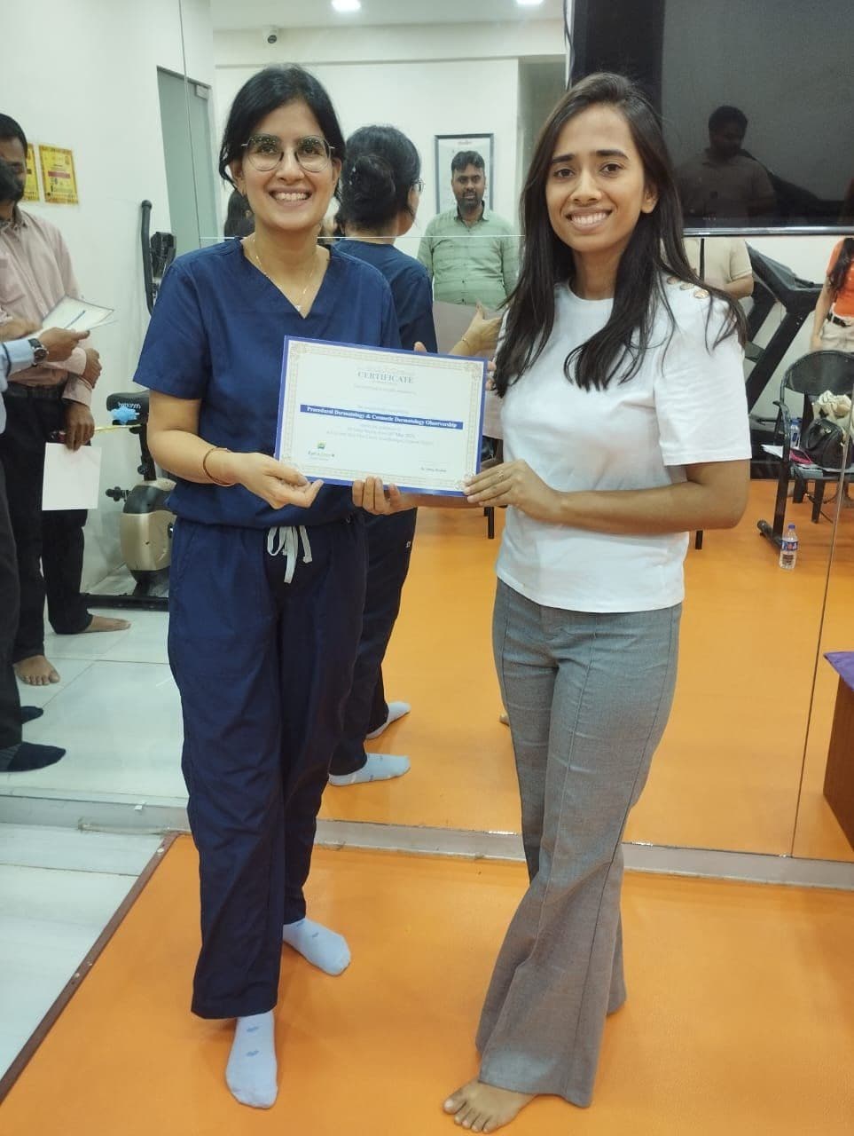 Dr. Neha Shukla presenting certificate — graduate 6