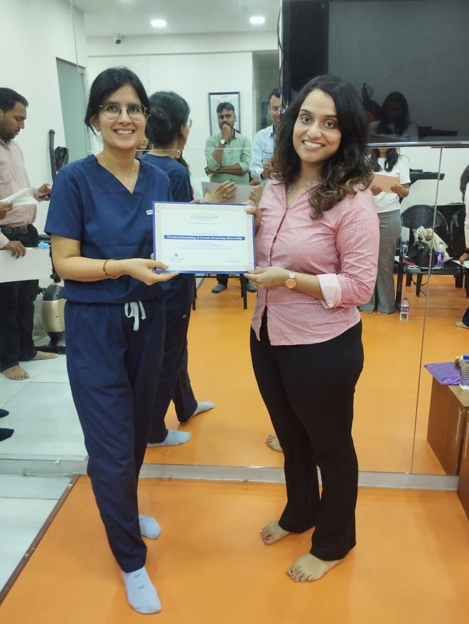 Dr. Neha Shukla presenting certificate — graduate 7