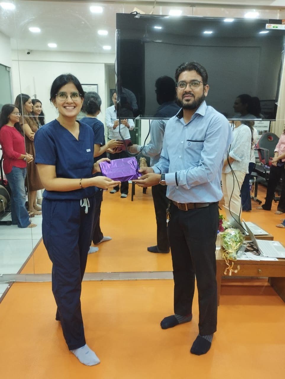 Dr. Neha Shukla presenting certificate — graduate 9